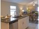 Kitchen island with granite countertops and stainless steel dishwasher at 10383 Blue Plume Ct, Riverview, FL 33578