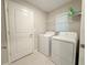 Laundry room with washer, dryer, and shelving at 10383 Blue Plume Ct, Riverview, FL 33578