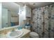 Clean bathroom with shower/tub combo and seashell-themed shower curtain at 11485 Oakhurst Rd # A203, Largo, FL 33774