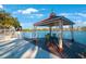 Lakeside gazebo with table and chairs, offering peaceful views at 11485 Oakhurst Rd # A203, Largo, FL 33774
