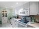 Well-equipped kitchen with white cabinets and a breakfast nook at 11485 Oakhurst Rd # A203, Largo, FL 33774