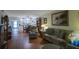 Open living area with hardwood floors and view of dining area at 11485 Oakhurst Rd # A203, Largo, FL 33774