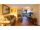 Living area with hardwood floors, sofa, and patio access at 11485 Oakhurst Rd # A203, Largo, FL 33774
