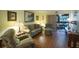 Living room with hardwood floors, sofa, and access to a patio at 11485 Oakhurst Rd # A203, Largo, FL 33774