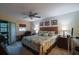 Spacious Primary bedroom with king-size bed and access to a balcony at 11485 Oakhurst Rd # A203, Largo, FL 33774