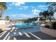 Inviting community pool with surrounding lounge chairs and gazebo at 11485 Oakhurst Rd # A203, Largo, FL 33774