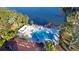 Community pool with spa, deck, and pergola overlooking a lake at 11485 Oakhurst Rd # A203, Largo, FL 33774