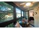 Relaxing screened balcony with seating area and view of lush greenery at 11485 Oakhurst Rd # A203, Largo, FL 33774