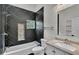 Modern bathroom features dark tile and white tile backsplash with a shower and single vanity at 1315 Cowart Rd, Plant City, FL 33567