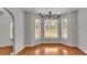 Bright dining area with hardwood floors, large bay window, and chandelier for elegant dining at 1315 Cowart Rd, Plant City, FL 33567