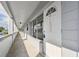 White building exterior with walkway and individual apartment entrances at 4300 58Th N St # 1907, Kenneth City, FL 33709
