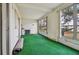 Spacious Florida room with green carpet and multiple windows at 4300 58Th N St # 1907, Kenneth City, FL 33709
