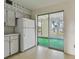 Cozy kitchen with white cabinets and sliding glass door to patio at 4300 58Th N St # 1907, Kenneth City, FL 33709