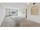 Bright living room featuring a large window and built-in shelving at 4300 58Th N St # 1907, Kenneth City, FL 33709