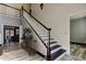 Grand staircase in entryway with dark wood and white railings at 436 Lafayette Blvd, Oldsmar, FL 34677