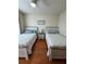Bedroom with two twin beds and wood floors at 1216 S Missouri Ave # 317, Clearwater, FL 33756