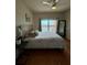 Main bedroom with wood floors and balcony access at 1216 S Missouri Ave # 317, Clearwater, FL 33756