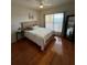 Bright bedroom with wood floors and a large window at 1216 S Missouri Ave # 317, Clearwater, FL 33756