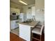 Kitchen features white cabinets, breakfast bar, and modern appliances at 1216 S Missouri Ave # 317, Clearwater, FL 33756