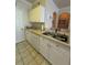 Well-equipped kitchen with white cabinets and modern appliances at 1216 S Missouri Ave # 317, Clearwater, FL 33756