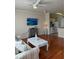 Bright living room with hardwood floors, comfy sofa, and a large TV at 1216 S Missouri Ave # 317, Clearwater, FL 33756