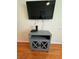 Gray media console with TV and entertainment components at 1216 S Missouri Ave # 317, Clearwater, FL 33756