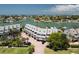 Aerial view showcasing condo building, parking, and waterfront location at 370 Pinellas Bayway S # E, Tierra Verde, FL 33715
