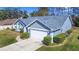 Single-story home with gray exterior, white garage door, and manicured lawn at 6085 Fall River Dr, New Port Richey, FL 34655