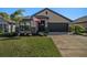 One-story home with attached garage and landscaped lawn at 6110 162Nd E Ave, Parrish, FL 34219