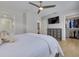 Spacious bedroom with a queen bed, walk-in closet, and built-in TV at 1615 Santa Barbara Dr, Dunedin, FL 34698