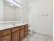 Clean bathroom with wood vanity, large mirror, and tile floor at 2632 River Preserve Ct, Bradenton, FL 34208