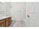 Clean bathroom with wood vanity and tile floor at 2632 River Preserve Ct, Bradenton, FL 34208