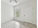 Bright bedroom with tile floors and large window at 2632 River Preserve Ct, Bradenton, FL 34208