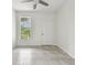 Simple bedroom with ceiling fan and large window at 2632 River Preserve Ct, Bradenton, FL 34208