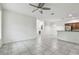 Open living room with tile floors and kitchen view at 2632 River Preserve Ct, Bradenton, FL 34208