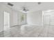 Large living room with tile floors and access to balcony at 2632 River Preserve Ct, Bradenton, FL 34208
