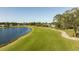 Aerial view of a golf course community with houses and a pond at 3716 Maxwell Park Dr, Sun City Center, FL 33573