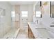 Modern bathroom featuring double sinks, marble countertop and a large walk-in shower at 1948 Jeffords St, Clearwater, FL 33764