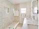 Bright bathroom with a walk-in shower, single vanity, and marble countertop at 1948 Jeffords St, Clearwater, FL 33764