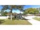 Tan single story home with attached garage and a spacious yard at 1948 Jeffords St, Clearwater, FL 33764