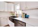 Updated kitchen with farmhouse sink and stainless steel dishwasher at 1948 Jeffords St, Clearwater, FL 33764