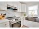 Sleek kitchen with stainless steel appliances and marble backsplash at 1948 Jeffords St, Clearwater, FL 33764