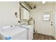 Laundry room with washer, dryer and extra storage at 3322 W Dorchester St, Tampa, FL 33611