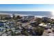 Wide aerial view of the coastline and surrounding neighborhood at 12000 Gulf Blvd # 501-W, Treasure Island, FL 33706