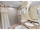 Clean bathroom with shower, granite vanity and a large mirror at 12000 Gulf Blvd # 501-W, Treasure Island, FL 33706