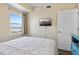 Bedroom with a queen bed and TV, offering an ocean view at 12000 Gulf Blvd # 501-W, Treasure Island, FL 33706