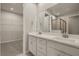 Modern bathroom with double vanity, white cabinets and walk-in shower at 20363 Symphony Pl, Venice, FL 34293