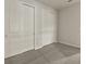 Bright bedroom featuring two large closets and neutral-toned carpet at 20363 Symphony Pl, Venice, FL 34293
