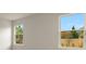 Well-lit bedroom with two large windows and neutral walls at 20363 Symphony Pl, Venice, FL 34293