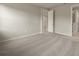 Bright bedroom with neutral carpeting and an open door to hallway at 20363 Symphony Pl, Venice, FL 34293